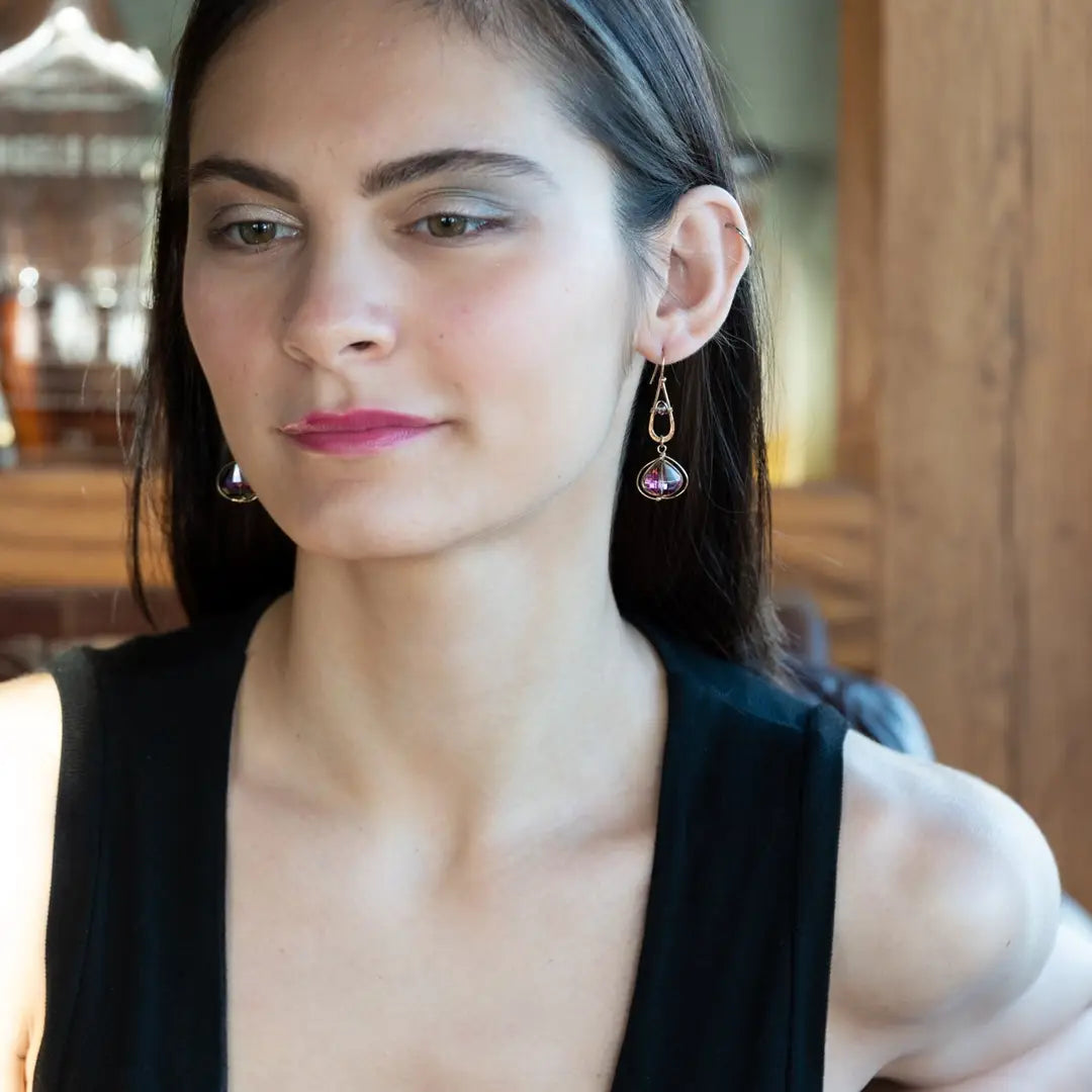 A pair of gold-filled wrapped fuchsia two-toned hematite crystal drop earrings with a hammered bronze mini drop and a crystal accent on gold filled earring hooks