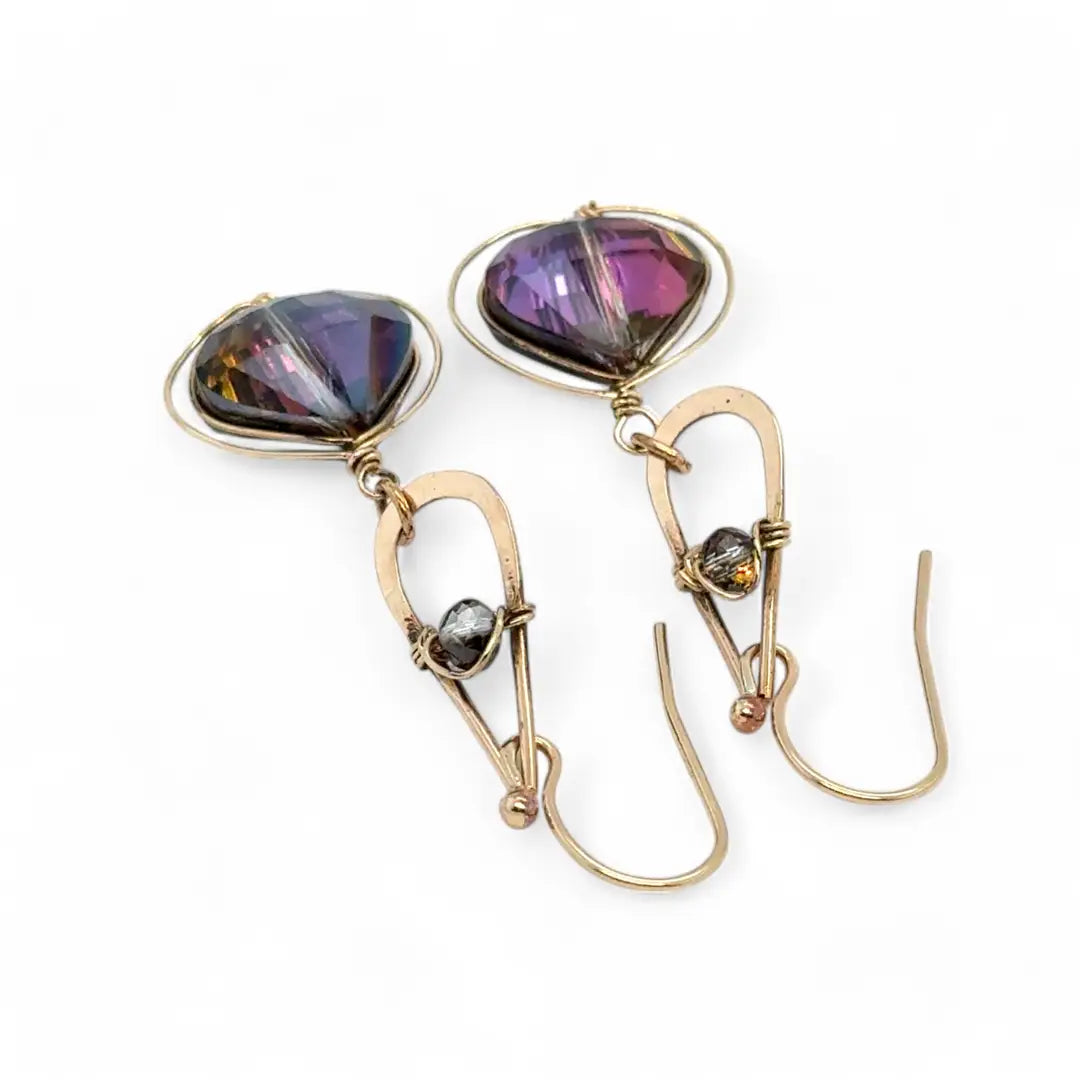 A pair of gold-filled wrapped fuchsia two-toned hematite crystal drop earrings with a hammered bronze mini drop and a crystal accent on gold filled earring hooks