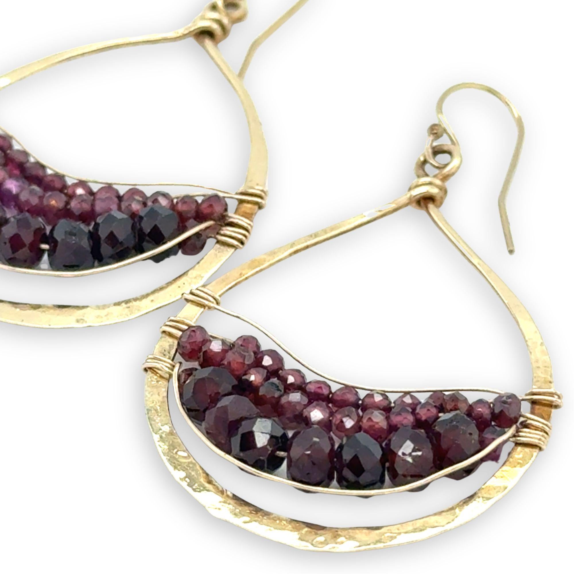 Fat hammered brass drop earrings layered with faceted garnet gemstone variety in gold filled wire