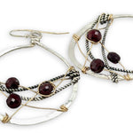 handmade sterling silver hoops with garnet faceted coins, gold-filled wire and darkened sterling silver twisted wire twisted within