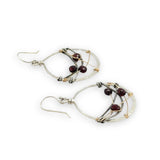 handmade sterling silver hoops with garnet faceted coins, gold-filled wire and darkened sterling silver twisted wire twisted within