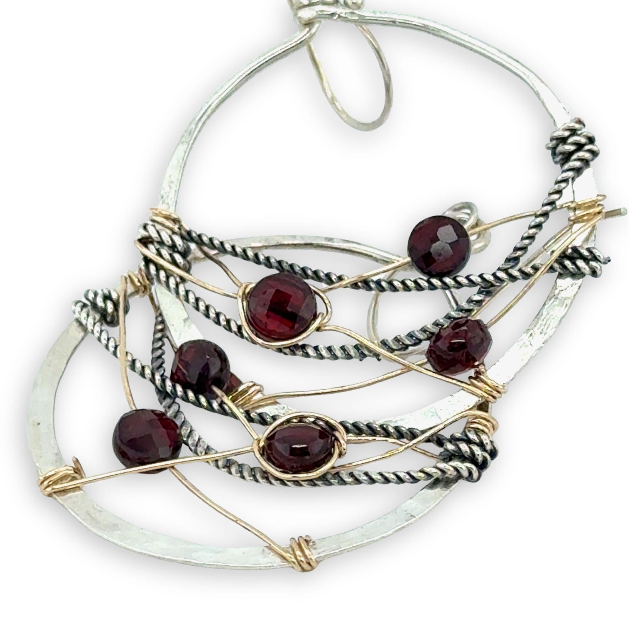 handmade sterling silver hoops with garnet faceted coins, gold-filled wire and darkened sterling silver twisted wire twisted within