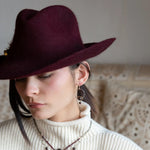 Sterling silver hammered hoops holding onto layers of bronze hammered wire wrapping a faceted garnet gemstone with a rich red fresh water pearl dangle earring