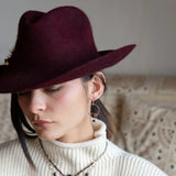 Sterling silver hammered hoops holding onto layers of bronze hammered wire wrapping a faceted garnet gemstone with a rich red fresh water pearl dangle earring