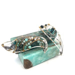 Amazonite, chrysocolla, blue quartz, and moonstone gemstones held within a handmade sterling silver wave shaped bracelet with oxidized twist, gold filled, and brass wire accents