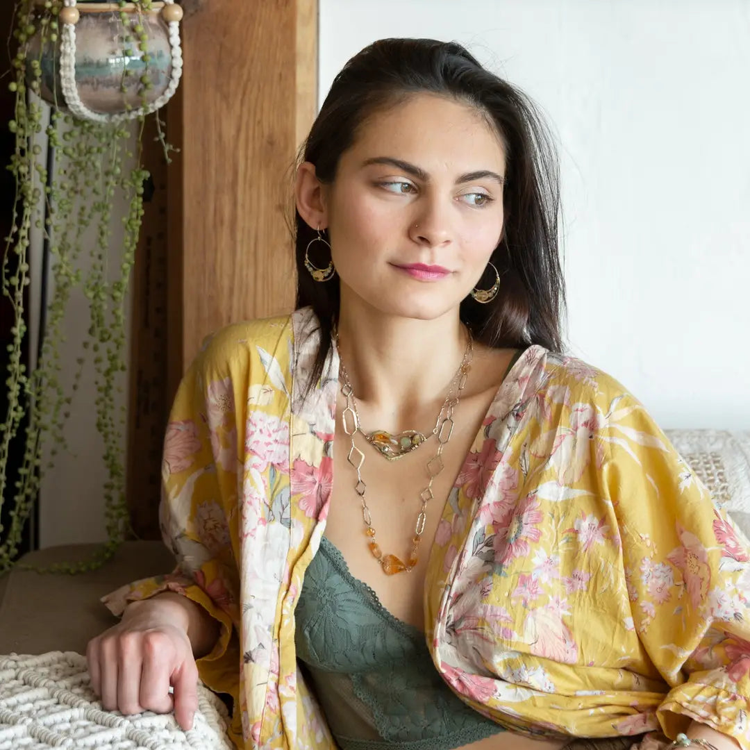 An oxidized sterling silver wedge pendant with waves of hammered sterling silver and brass wires, mixed with citrine, jade, crystal, and yellow opal gemstones to form this gemstone wedge necklace