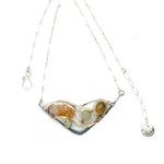 An oxidized sterling silver wedge pendant with waves of hammered sterling silver and brass wires, mixed with citrine, jade, crystal, and yellow opal gemstones to form this gemstone wedge necklace