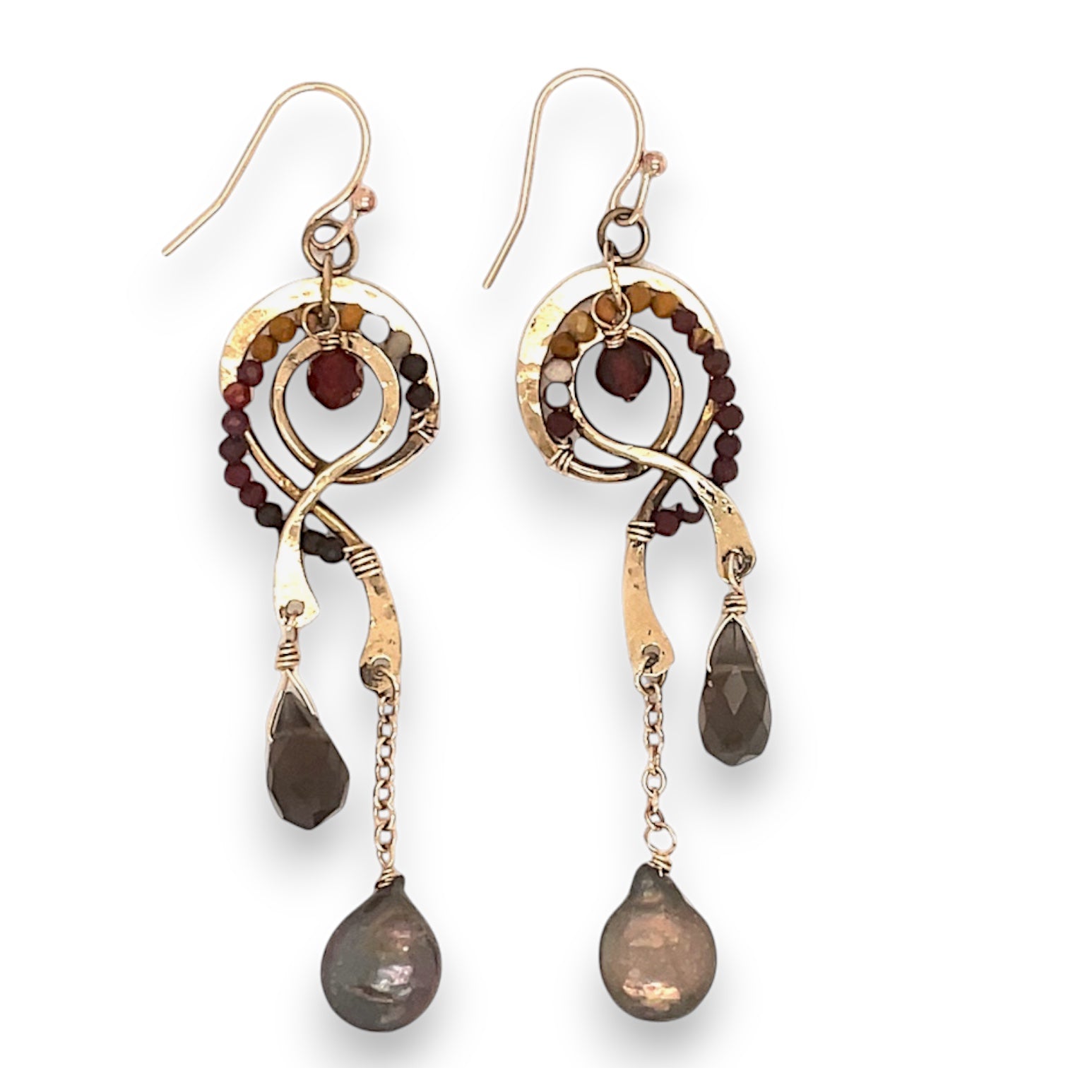 A pair of brass spiral earrings with micro faceted mookaite, garnet, a smokey quartz drop, and a chocolate fresh water pearl coins drop on gold-filled chains.