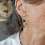 hammered mini brass oval earrings with faceted quartz coins wrapped in gold filled wire accented with aquamarine and blue goldstone gemstones