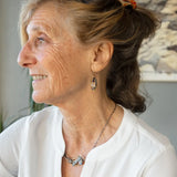 hammered mini brass oval earrings with faceted quartz coins wrapped in gold filled wire accented with aquamarine and blue goldstone gemstones