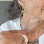 hammered mini brass oval earrings with faceted quartz coins wrapped in gold filled wire accented with aquamarine and blue goldstone gemstones