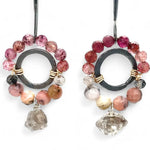 Darkened sterling silver ring surrounded by pink tourmaline and opal gemstones with a herkimer diamond dangle, attached to a darkened sterling silver twisted bar top earring