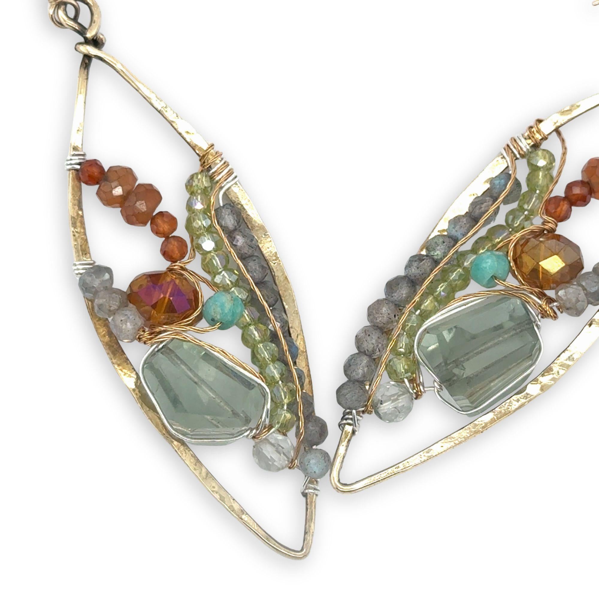 Green amethyst nuggets surrounded by labradorite, hessonite garnet, citrine, crystal, and amazonite gemstones wrapped in sterling silver and brass twist wires on a handmade hammered brass marquise earrings