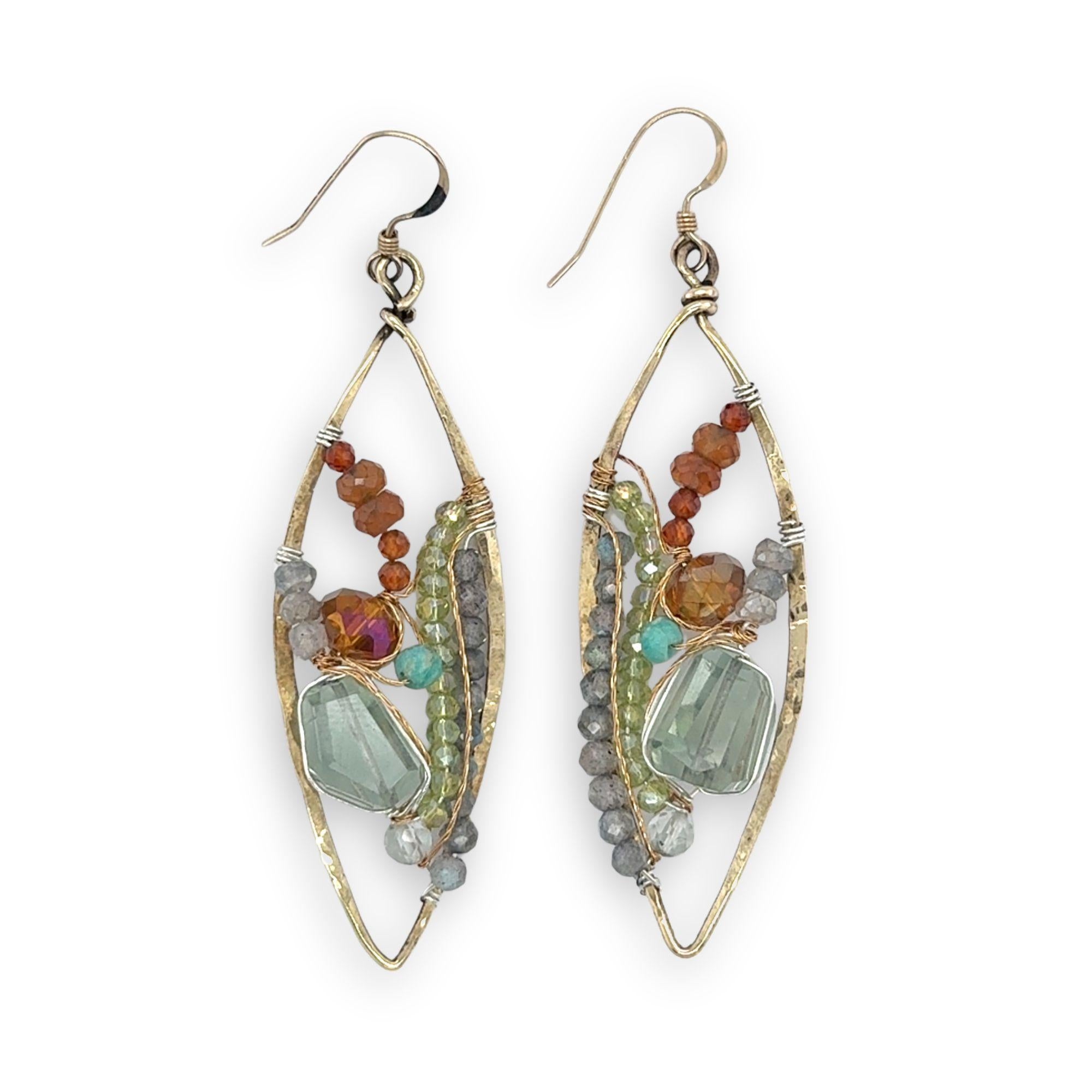 Green amethyst nuggets surrounded by labradorite, hessonite garnet, citrine, crystal, and amazonite gemstones wrapped in sterling silver and brass twist wires on a handmade hammered brass marquise earrings