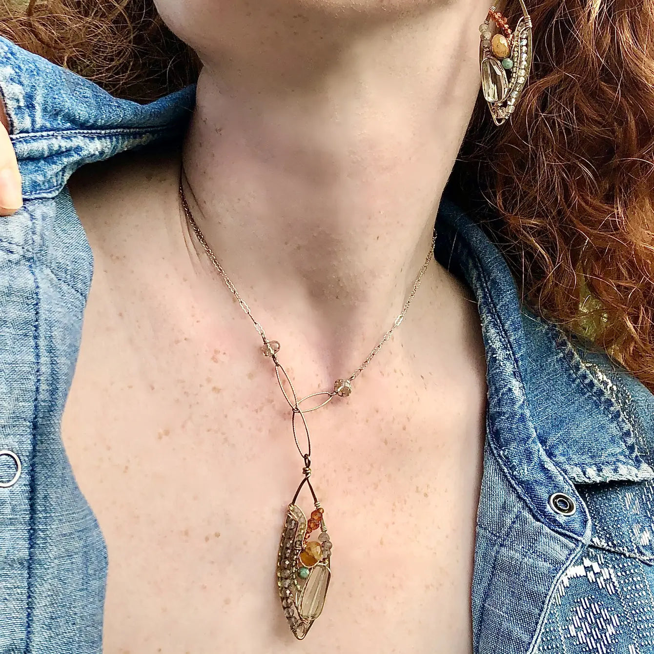 a hand formed brass marquise pendant adorned with green amethyst, labradorite, hessonite garnet, citrine, crystal and amazonite gemstone necklace