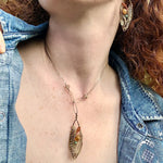a hand formed brass marquise pendant adorned with green amethyst, labradorite, hessonite garnet, citrine, crystal and amazonite gemstone necklace