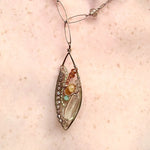 a hand formed brass marquise pendant adorned with green amethyst, labradorite, hessonite garnet, citrine, crystal and amazonite gemstone necklace