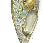 a hand formed brass marquise pendant adorned with green amethyst, labradorite, hessonite garnet, citrine, crystal and amazonite gemstone necklace