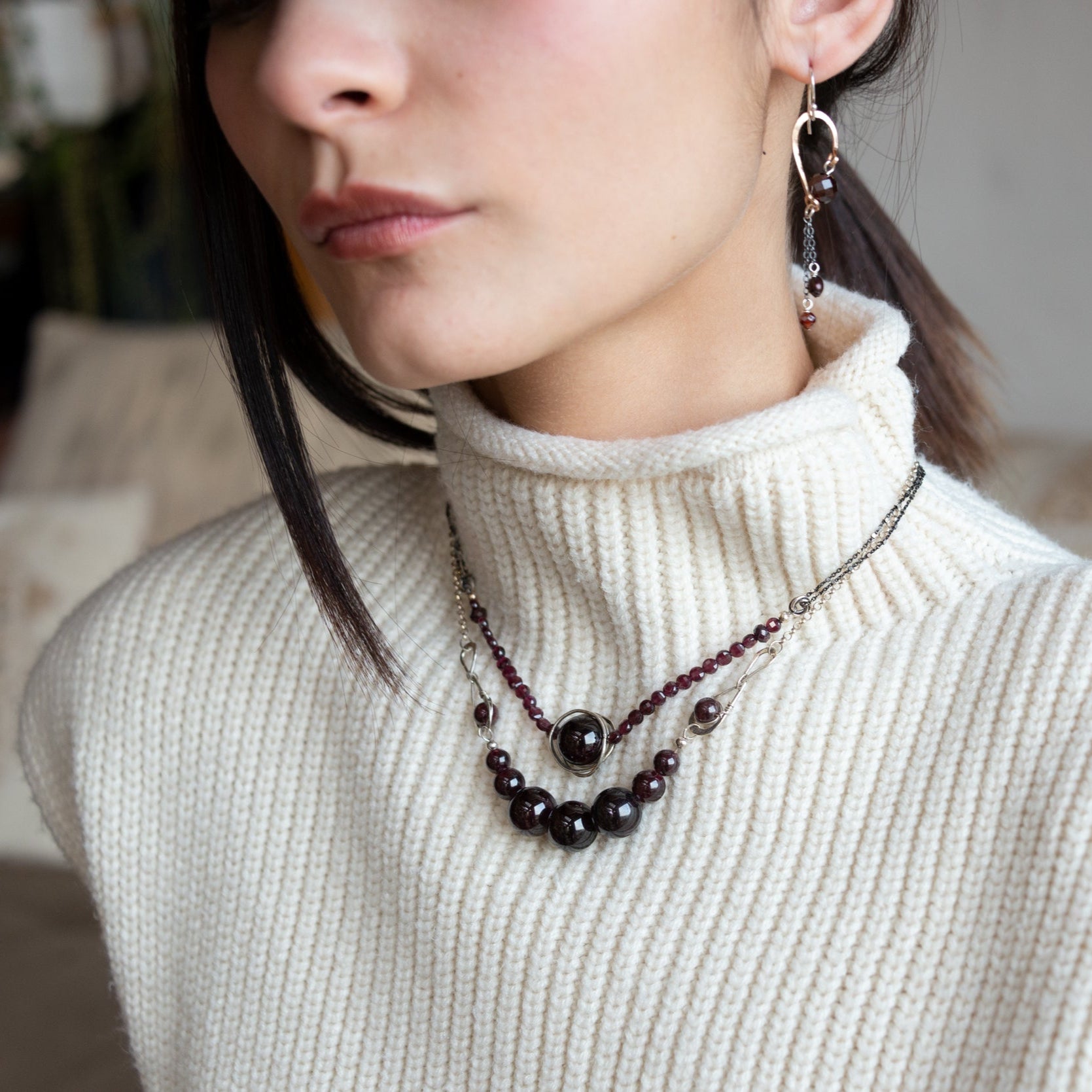 Smooth garnet sphere gemstones are suspended between handmade sterling silver hammered teardrops on sterling rolo chain necklace