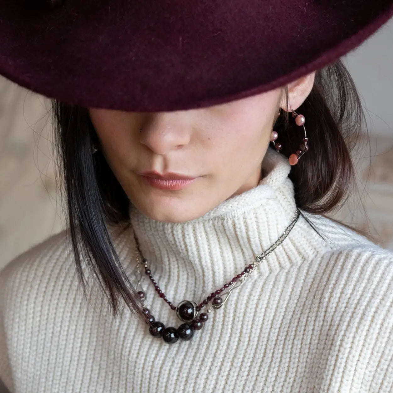 Smooth garnet sphere gemstones are suspended between handmade sterling silver hammered teardrops on sterling rolo chain necklace
