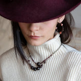 Smooth garnet sphere gemstones are suspended between handmade sterling silver hammered teardrops on sterling rolo chain necklace