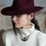 Smooth garnet sphere gemstones are suspended between handmade sterling silver hammered teardrops on sterling rolo chain necklace