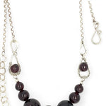 Smooth garnet sphere gemstones are suspended between handmade sterling silver hammered teardrops on sterling rolo chain necklace
