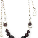 Smooth garnet sphere gemstones are suspended between handmade sterling silver hammered teardrops on sterling rolo chain necklace