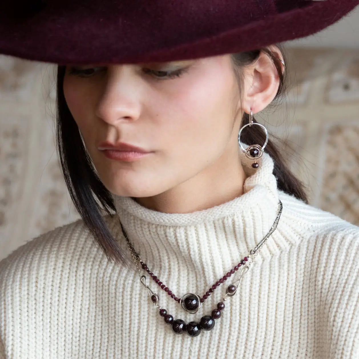 Smooth garnet sphere gemstones are suspended between handmade sterling silver hammered teardrops on sterling rolo chain necklace