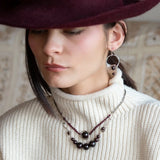 Smooth garnet sphere gemstones are suspended between handmade sterling silver hammered teardrops on sterling rolo chain necklace