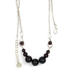 Smooth garnet sphere gemstones are suspended between handmade sterling silver hammered teardrops on sterling rolo chain necklace