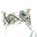 Variety of pyrite gemstones embroider a statement sterling silver handmade cuff bracelet, woven with gold filled and brass twist wires