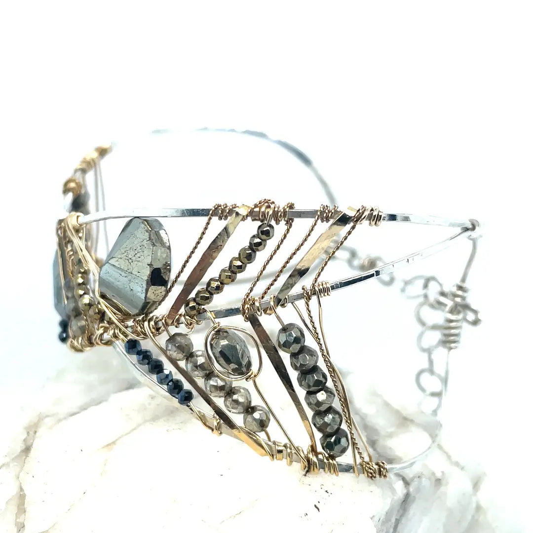 Variety of pyrite gemstones embroider a statement sterling silver handmade cuff bracelet, woven with gold filled and brass twist wires
