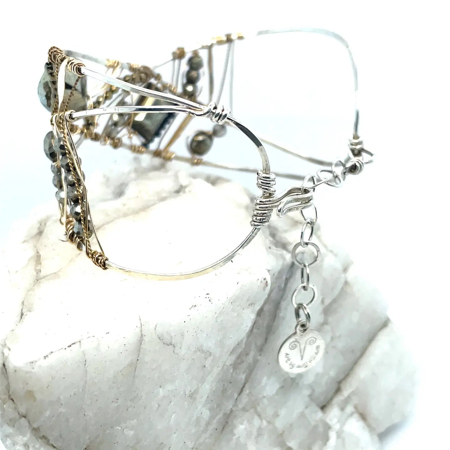 Variety of pyrite gemstones embroider a statement sterling silver handmade cuff bracelet, woven with gold filled and brass twist wires