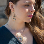 London blue quartz, pyrite, bloodstone, and blue tourmaline gemstones sit within a brass box pendant with sterling silver and gold filled wire accents on a sterling silver box chain