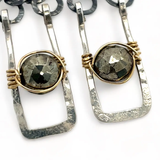 Sterling silver mini rectangle earrings holding faceted pyrite coin gemstones wrapped in gold filled wire, hanging from darkened sterling silver crinkle chain 