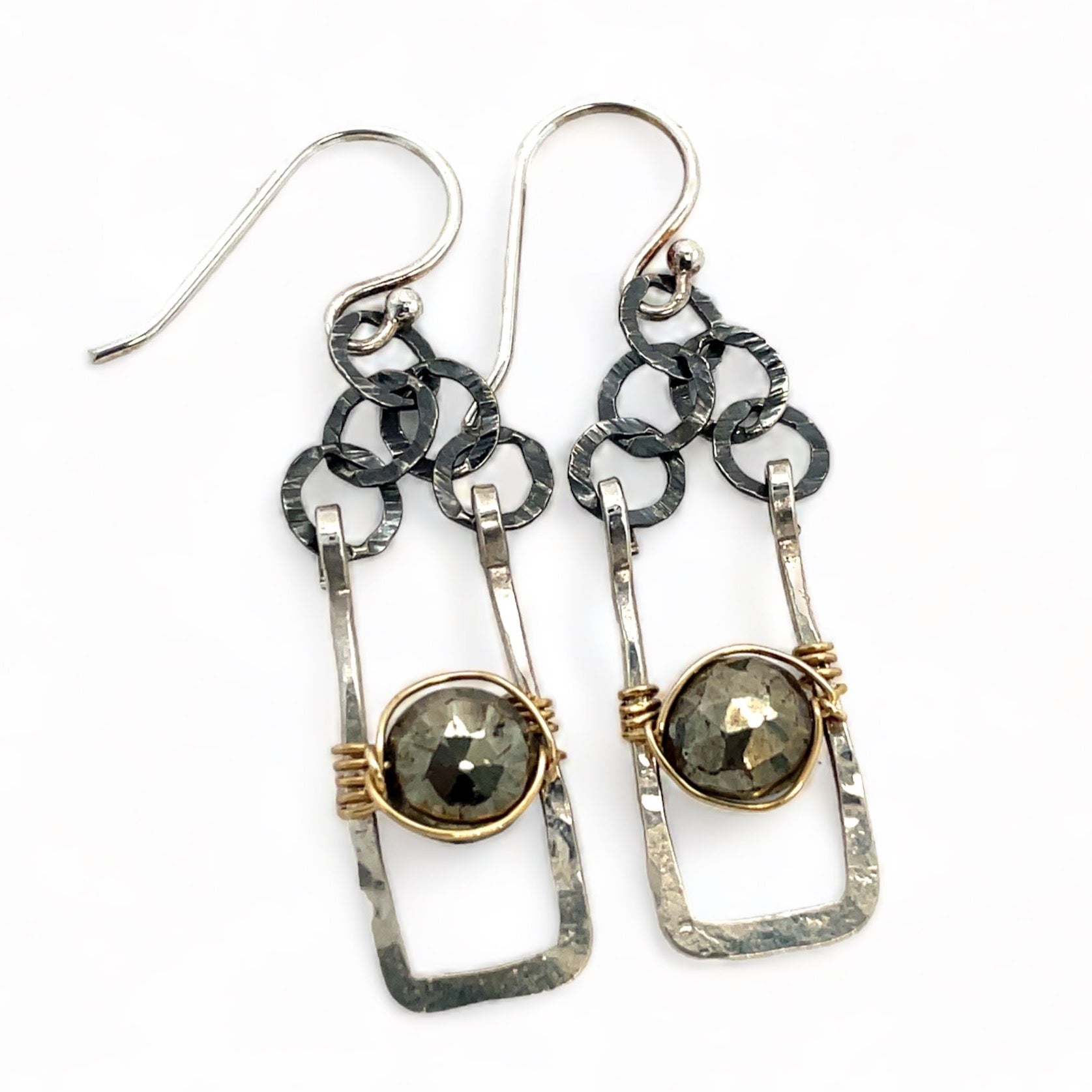 Sterling silver mini rectangle earrings holding faceted pyrite coin gemstones wrapped in gold filled wire, hanging from darkened sterling silver crinkle chain 