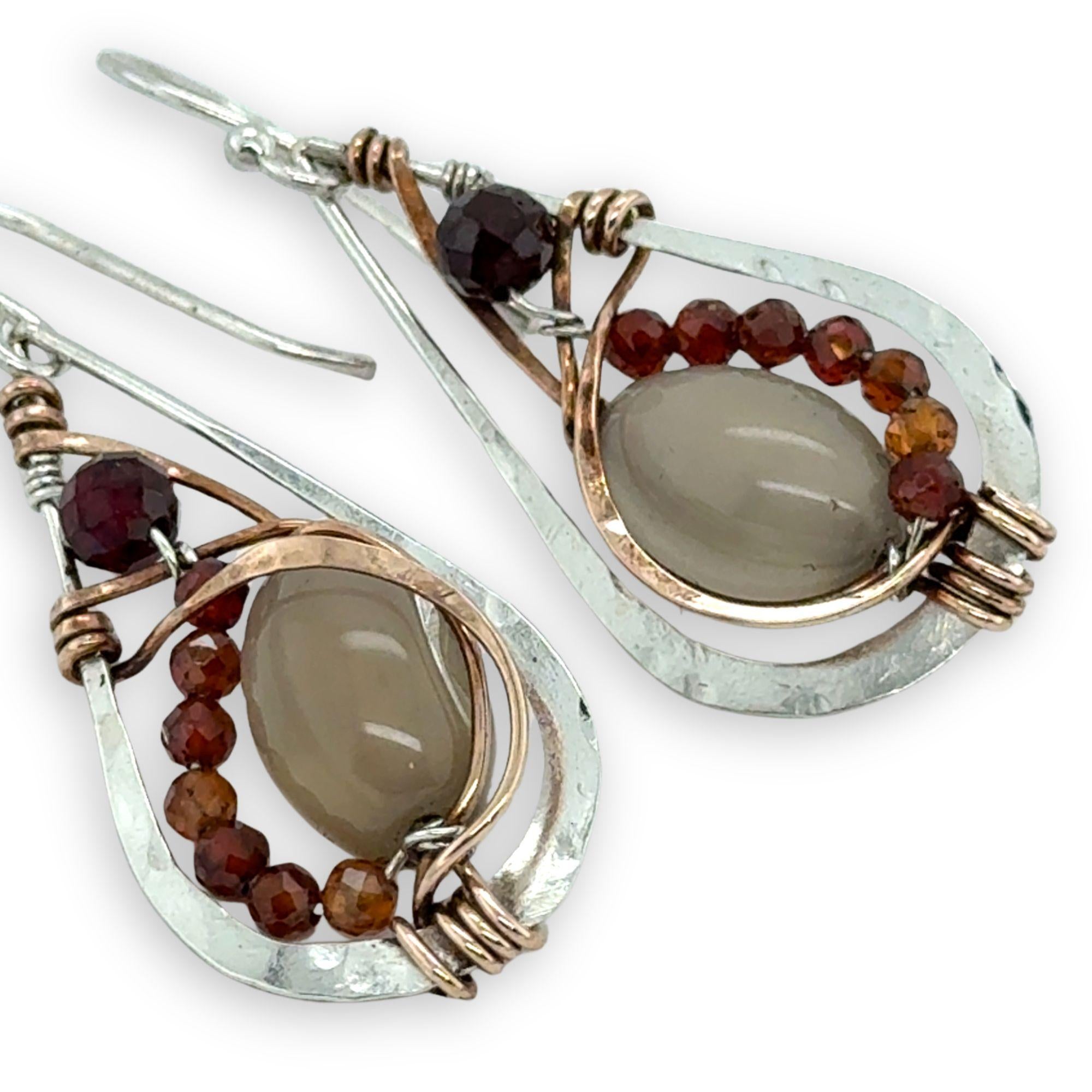 Small sterling silver hammered drop earrings embellished with glowing smooth moonstone oval wrapped in bronze wire and faceted hessonite gemstones