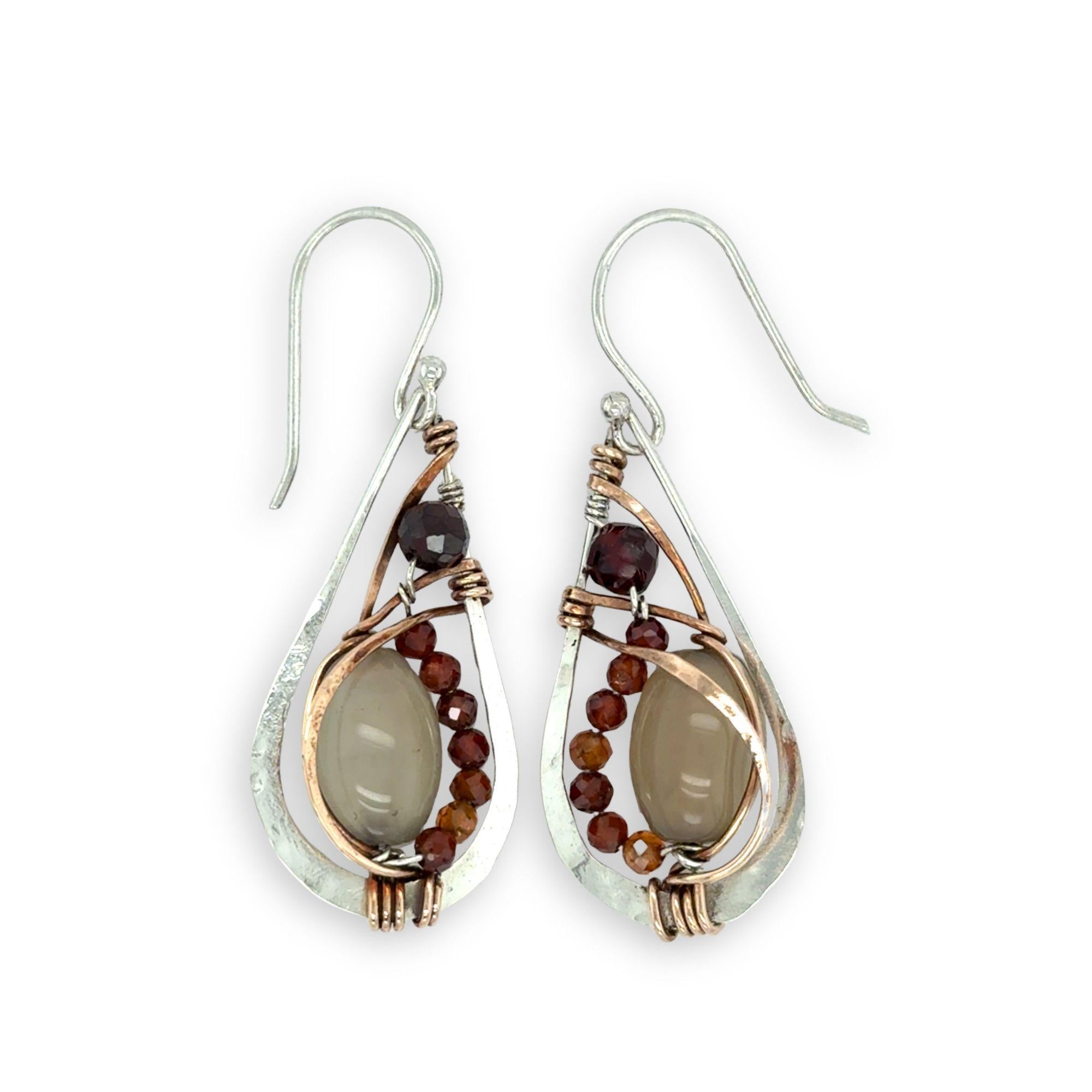 Small sterling silver hammered drop earrings embellished with glowing smooth moonstone oval wrapped in bronze wire and faceted hessonite gemstones