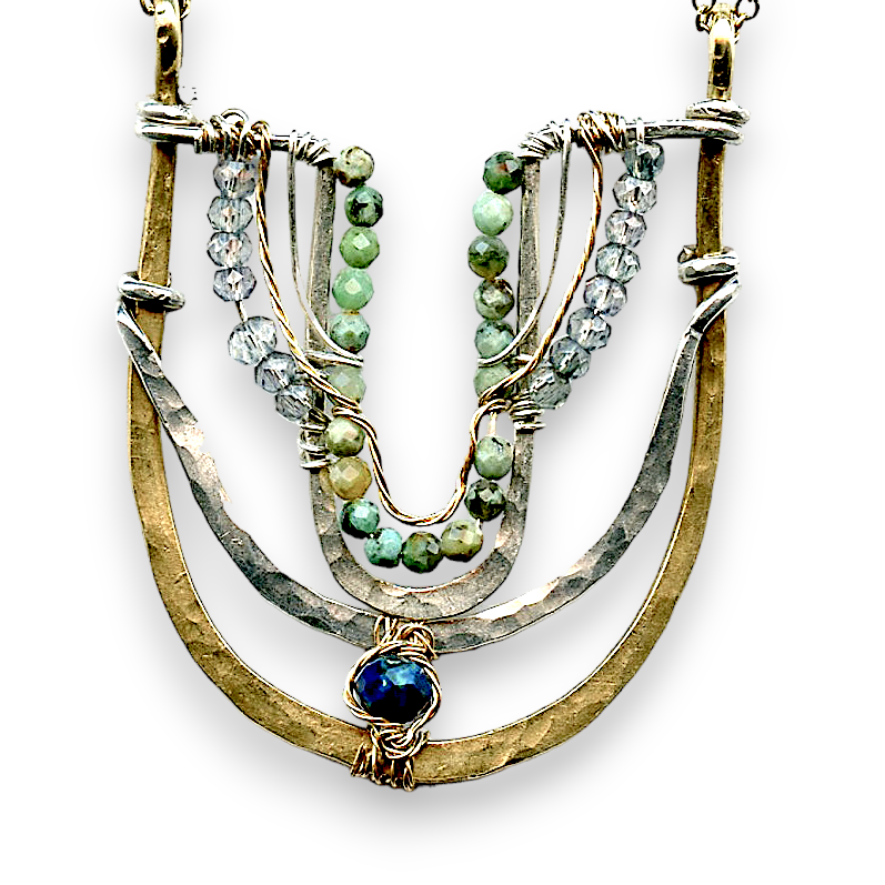 Handmade brass and sterling silver horseshoe pendant beaded with chrysocolla, turquoise, and blue quartz on a mixed sterling silver and gold filled chain