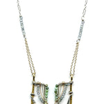 Handmade brass and sterling silver horseshoe pendant beaded with chrysocolla, turquoise, and blue quartz on a mixed sterling silver and gold filled chain