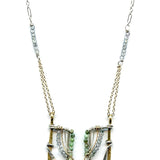 Handmade brass and sterling silver horseshoe pendant beaded with chrysocolla, turquoise, and blue quartz on a mixed sterling silver and gold filled chain