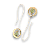 Tiny hammered brass hoops with green kyanite gemstones in center wrapped in 14k gold filled wire, hanging from handmade sterling silver long hook earrings