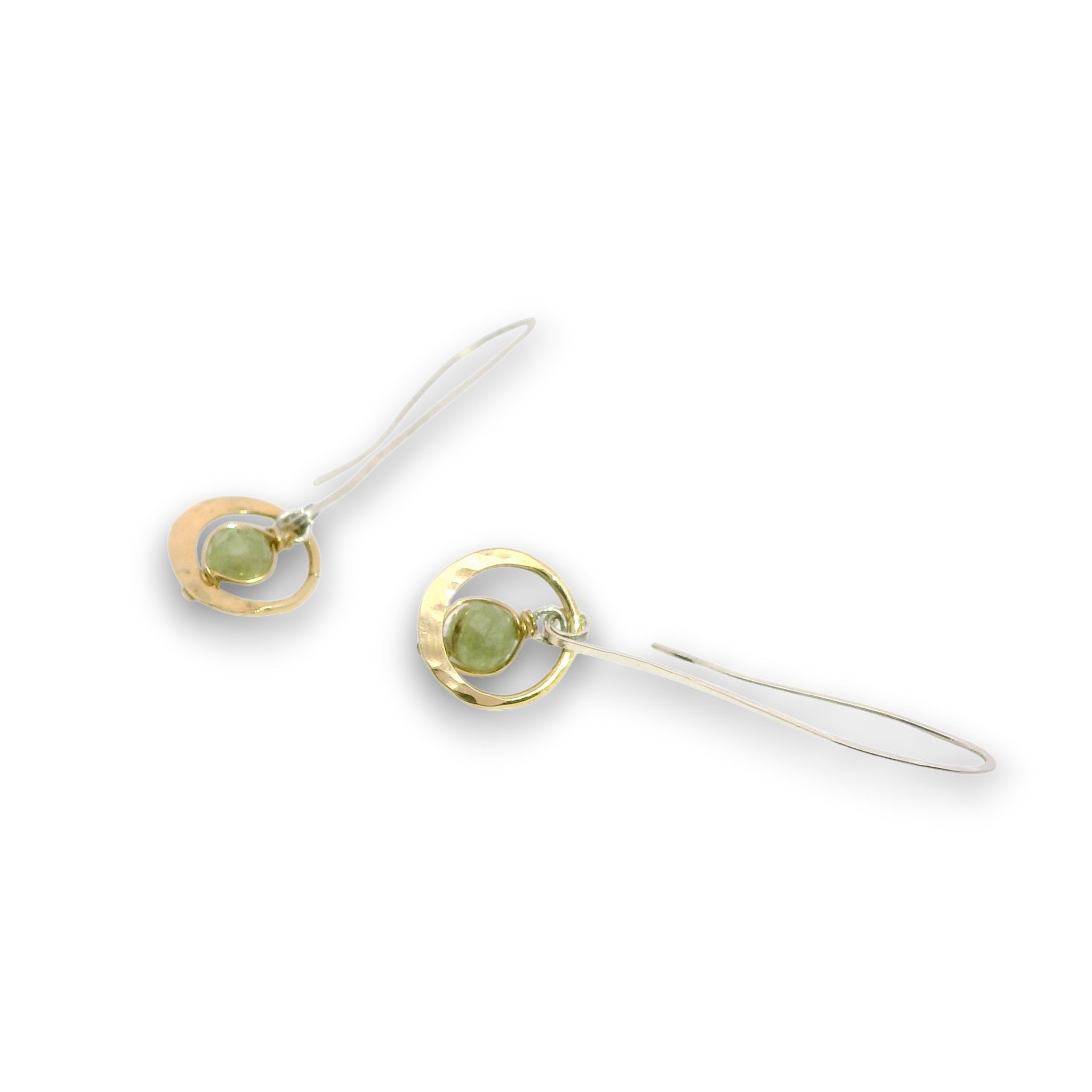 Tiny hammered brass hoops with green kyanite gemstones in center wrapped in 14k gold filled wire, hanging from handmade sterling silver long hook earrings