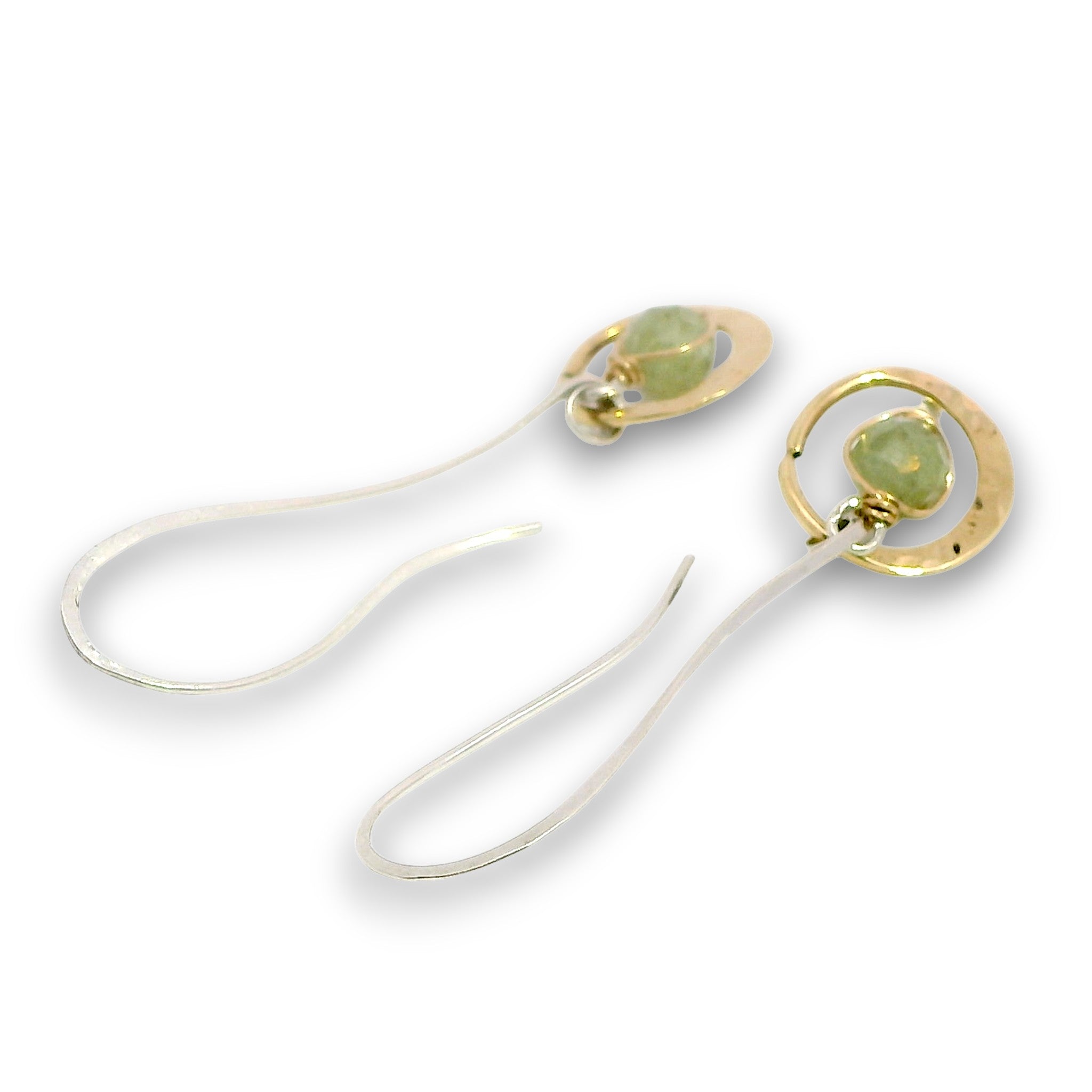 Tiny hammered brass hoops with green kyanite gemstones in center wrapped in 14k gold filled wire, hanging from handmade sterling silver long hook earrings