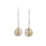 Tiny hammered brass hoops with green kyanite gemstones in center wrapped in 14k gold filled wire, hanging from handmade sterling silver long hook earrings