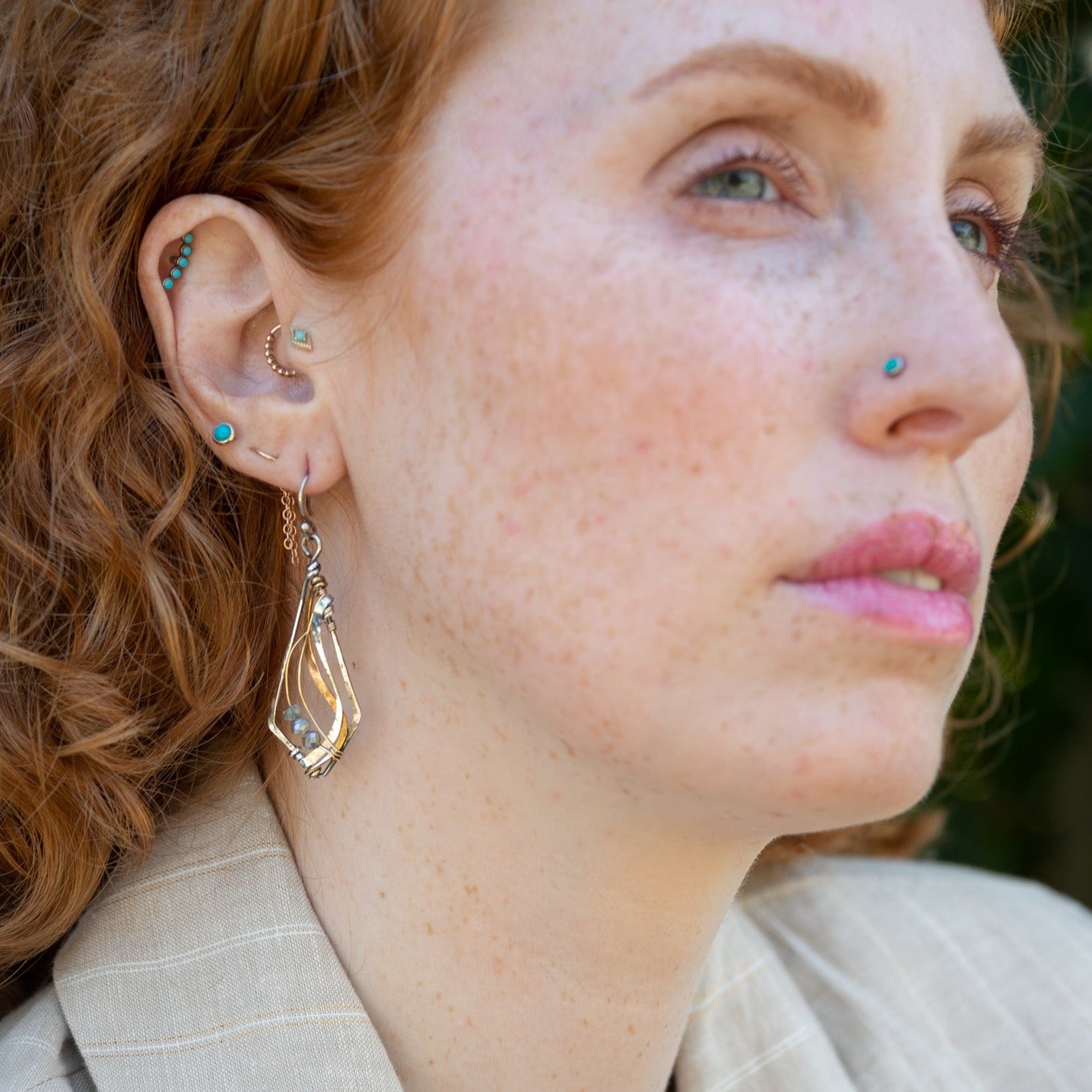 oxidized sterling silver arrow shaped earrings with brass and shiny sterling silver hammered swishes and labradorite gemstones on gold filled wire