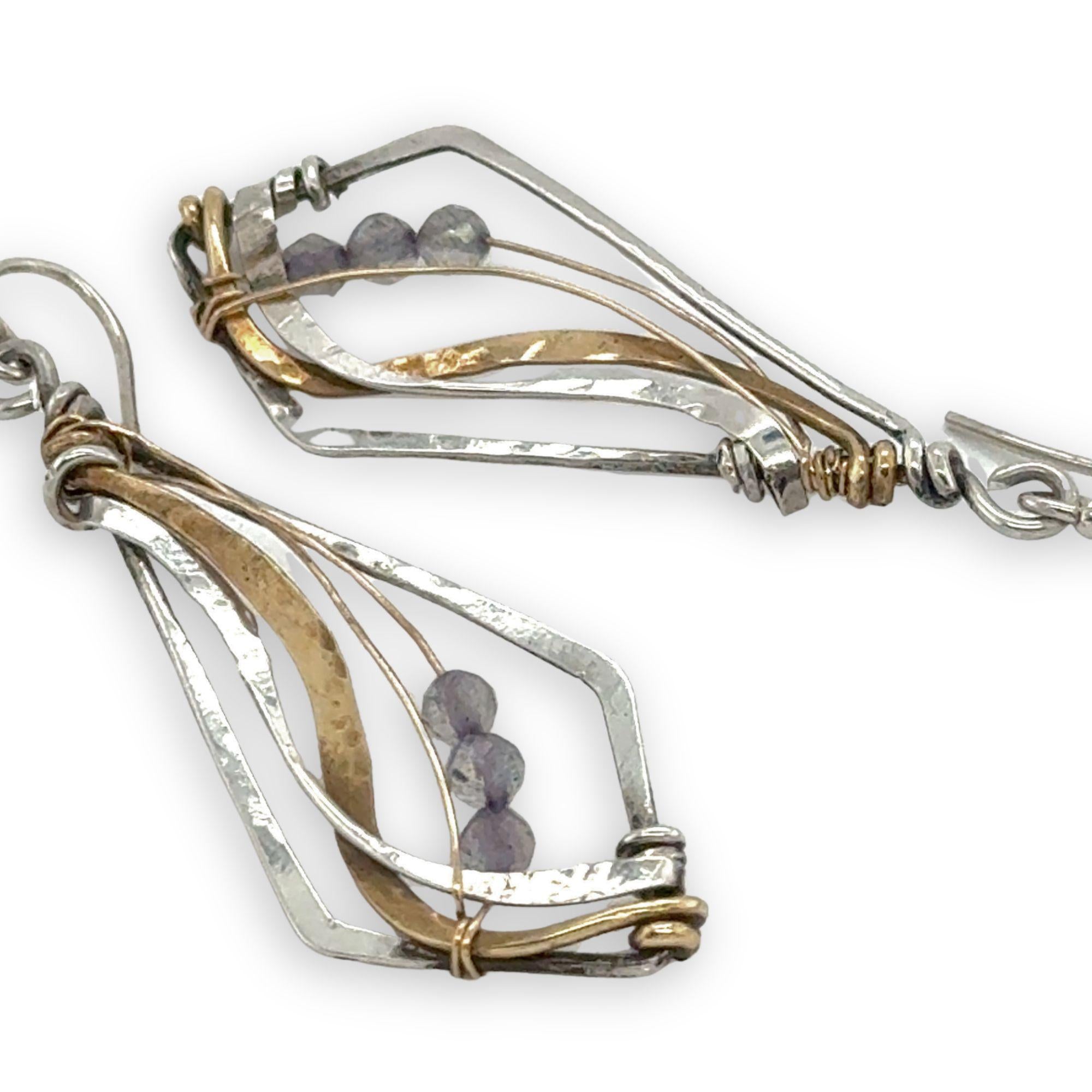 oxidized sterling silver arrow shaped earrings with brass and shiny sterling silver hammered swishes and labradorite gemstones on gold filled wire