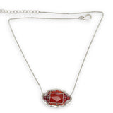 Red jasper tile surrounded by red and orange cubic zirconia gemstones in a hammered sterling silver pendant necklace