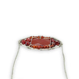 Red jasper tile surrounded by red and orange cubic zirconia gemstones in a hammered sterling silver pendant necklace